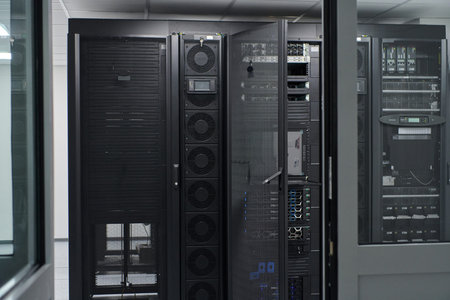 Data center server racks and network equipment in a secure IT room with cooling and cabling