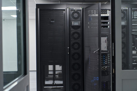 Data center server racks and network equipment in a modern IT infrastructure room for enterprise...