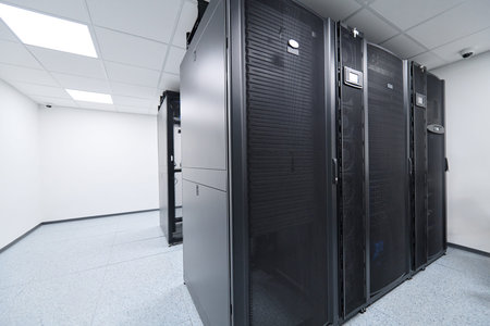 Modern data center server racks in a clean, climate-controlled server room for enterprise IT...