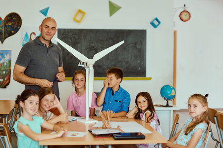 Teacher leading elementary students building a model wind turbine during a classroom STEM lesson