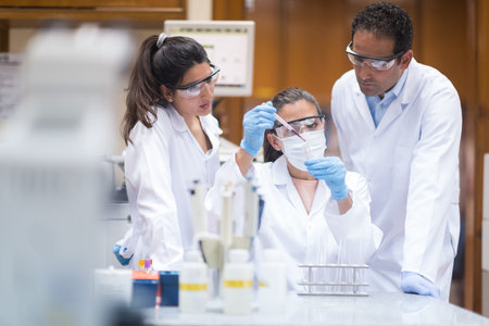 Medical team of doctors and a technician conducting blood testing in a clinical laboratory