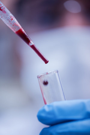 Middle Eastern lab technician and young doctors performing blood testing with pipette and test tube in medical laboratory