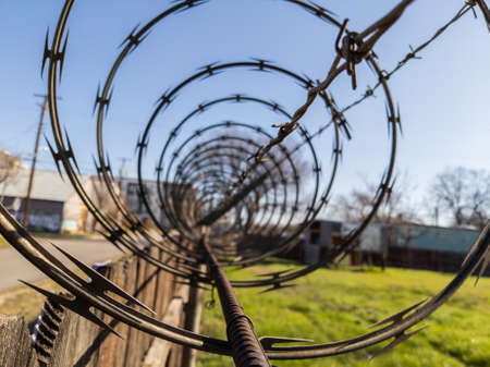 Closeup of barbed wire on top of fenceの写真素材