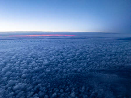 Aerial view above layer of small puffy altocumulus clouds at break of dawnの写真素材