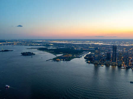 Aerial view of Jersey City, Ellis Island, and Liberty Island at sunset, view from One World Trade Center facing southwestのeditorial素材