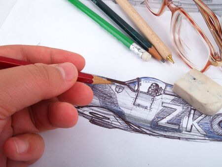 Hand making a drawing. close up on white background の写真素材