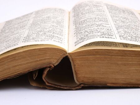 Open old book close up on white backgroundの写真素材