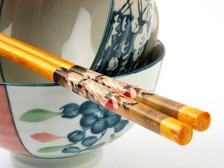 Rice bowl with chopsticks close up on white backgroundの写真素材