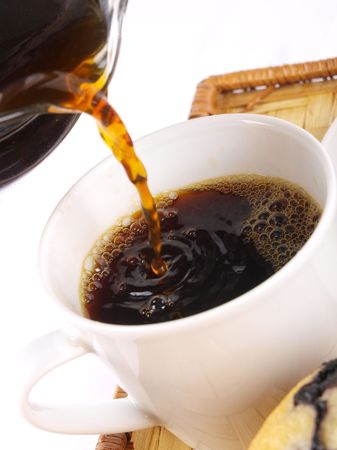Coffee being purred in to a cup. Close upの写真素材