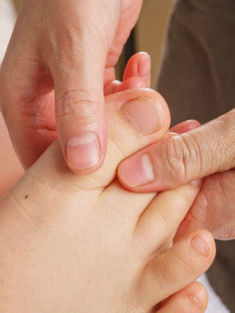 Female hands giving zone therapy. Close upの写真素材