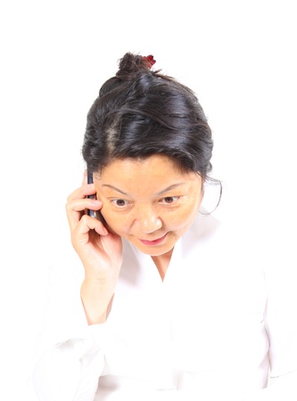 Happy Chinese business woman, talking in mobile phoneの写真素材