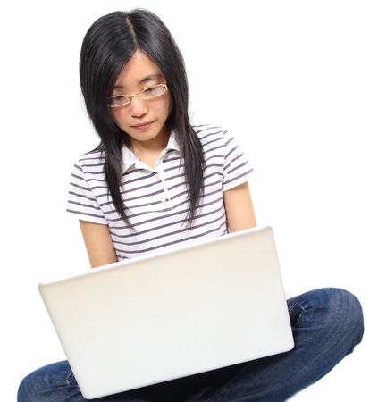 Young chinese woman sitting on the floor with laptopの写真素材