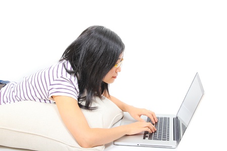 Young chinese woman sitting on the floor with laptopの写真素材