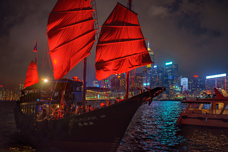 Hong Kong - November 19, 2015: Traditional boat with red sail and harbor at nightのeditorial素材