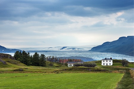 Iceland - July, 2008: Landscape with house and glacier in Southern Icelandのeditorial素材