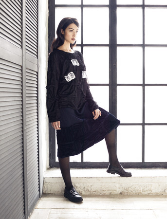 Brunette woman wearing black blouse and skirtの写真素材