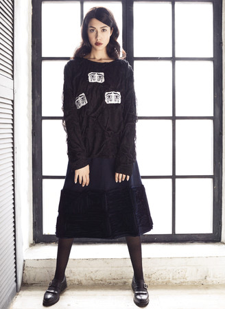 Brunette woman wearing black blouse and skirtの写真素材