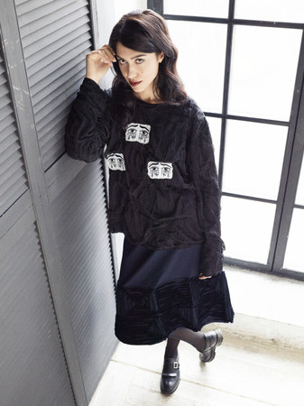 Brunette woman wearing black blouse and skirtの写真素材