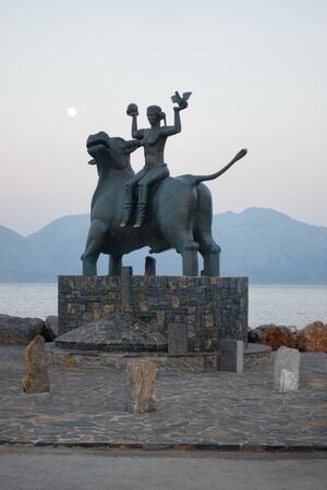 Agios Nikolaos, Crete, Greece - August 24, 2018 - Statue of Europe sitting on a bull at the waters edge.のeditorial素材