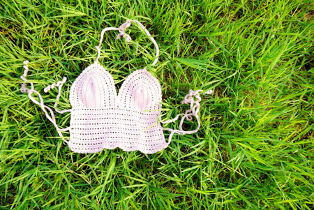 top bra bikini on green grass background, summer or holiday vacation conceptの写真素材