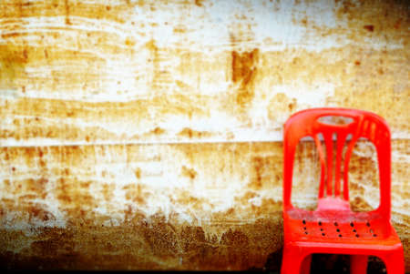 blur background of rustic metal texture, old wall dirty background and red chair, vintage and dark toneの写真素材