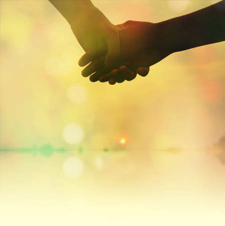 Couple holding hands in soft pastel tone with filter color, love conceptの写真素材