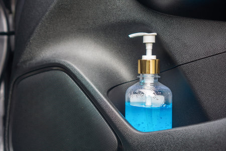 new normal lifestyle concept with closeup bottle of hand sanitizer alcohol gel in car for Corona or...