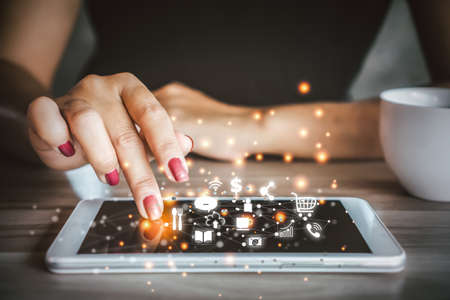 woman hand using tablet with connection digital social networking and internet of thingsの写真素材