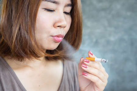 closeup Asian woman smoking cigarette ,unhealthy lifestyle conceptの写真素材