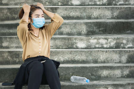 depressed unemployed Asian business woman wearing protective mask loosing her job caused  Coronavirus Covid-19 pandemic ,business crisis 2020の写真素材