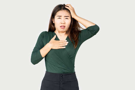 Asian woman having panic attack cause shortness of breath, can be used for heart attack , asthma and heartburn conceptの写真素材