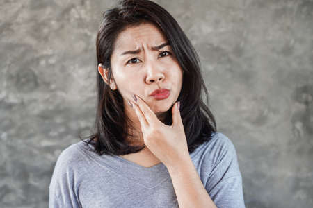 Asian woman having problem with Bell's Palsy/Facial Palsyの写真素材