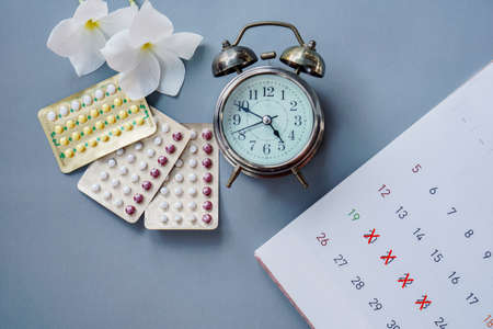 oral contraceptive pills, mark on calendar and alarm ,period time concept backgroundの写真素材