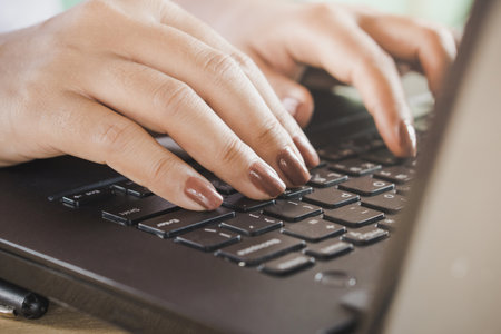 woman hand work on computer laptop closeup ,work from home office typing on keyboardの写真素材