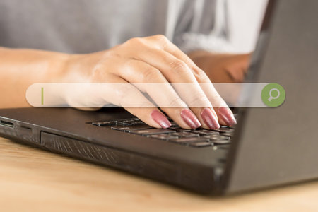 woman hand searching job on internet with computer notebookの写真素材