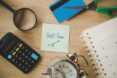 debt free from credit card concept background with calculator and clock on deskの写真素材