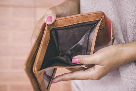 poor woman hand open empty wallet looking for money having problem  bankrupt ,broke conceptの写真素材