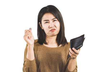 poor Asian woman hand holding empty wallet and one coin with sad face isolated on white backgroundの写真素材