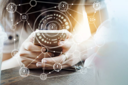 woman hand using smart phone with networking and modern communication technology backgroundの写真素材
