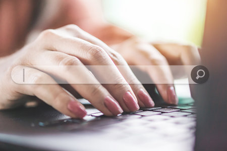 woman hand searching job or browsing internet data on computer notebookの写真素材