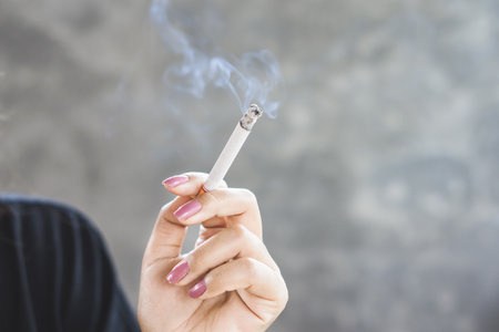 closeup woman hand smoking cigarette ,unhealthy lifestyle conceptの写真素材