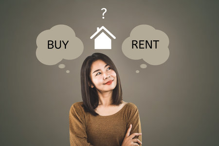 Asian woman thinking buy or rent home concept with question mark in backgroundの写真素材