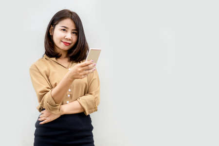 beautiful Asian business woman hand holding smart phoneの写真素材