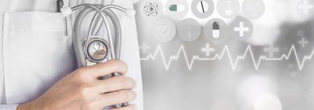 doctor holding stethoscope in hand with modern medical technology backgroundの写真素材