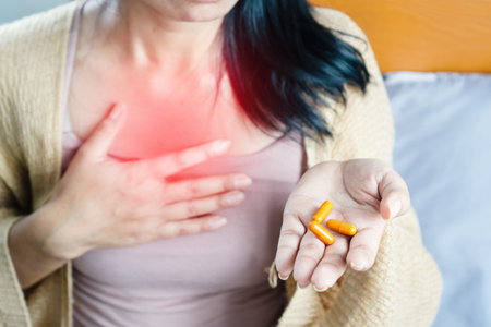 woman taking turmeric pill, or curcumin herb medicine for GERD, treatment for heartburn from acid...