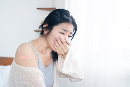 Asian woman feeling nausea and vomiting having allergic side effects after receiving the vaccineの写真素材