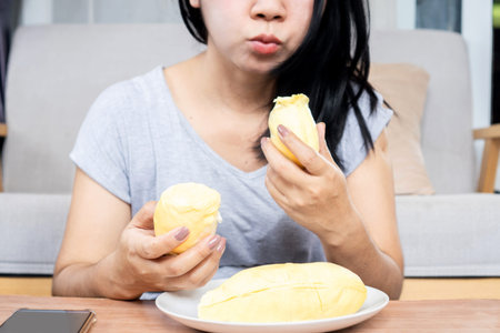Asian woman over eating Durian fruit, unhealthy lifestyle