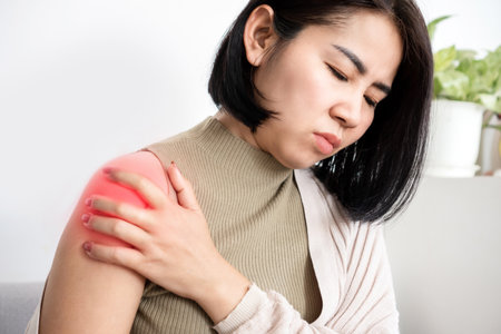 Asian woman suffering from frozen shoulder with pain and stiffness, Rotator cuff tear conceptの写真素材