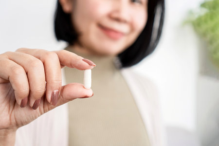 Asian woman holding a probiotic supplement pillの写真素材