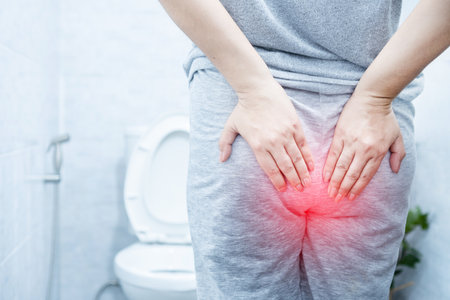 woman suffering from hemorrhoids hurting and bleeding
during bowel movements in a toiletの写真素材